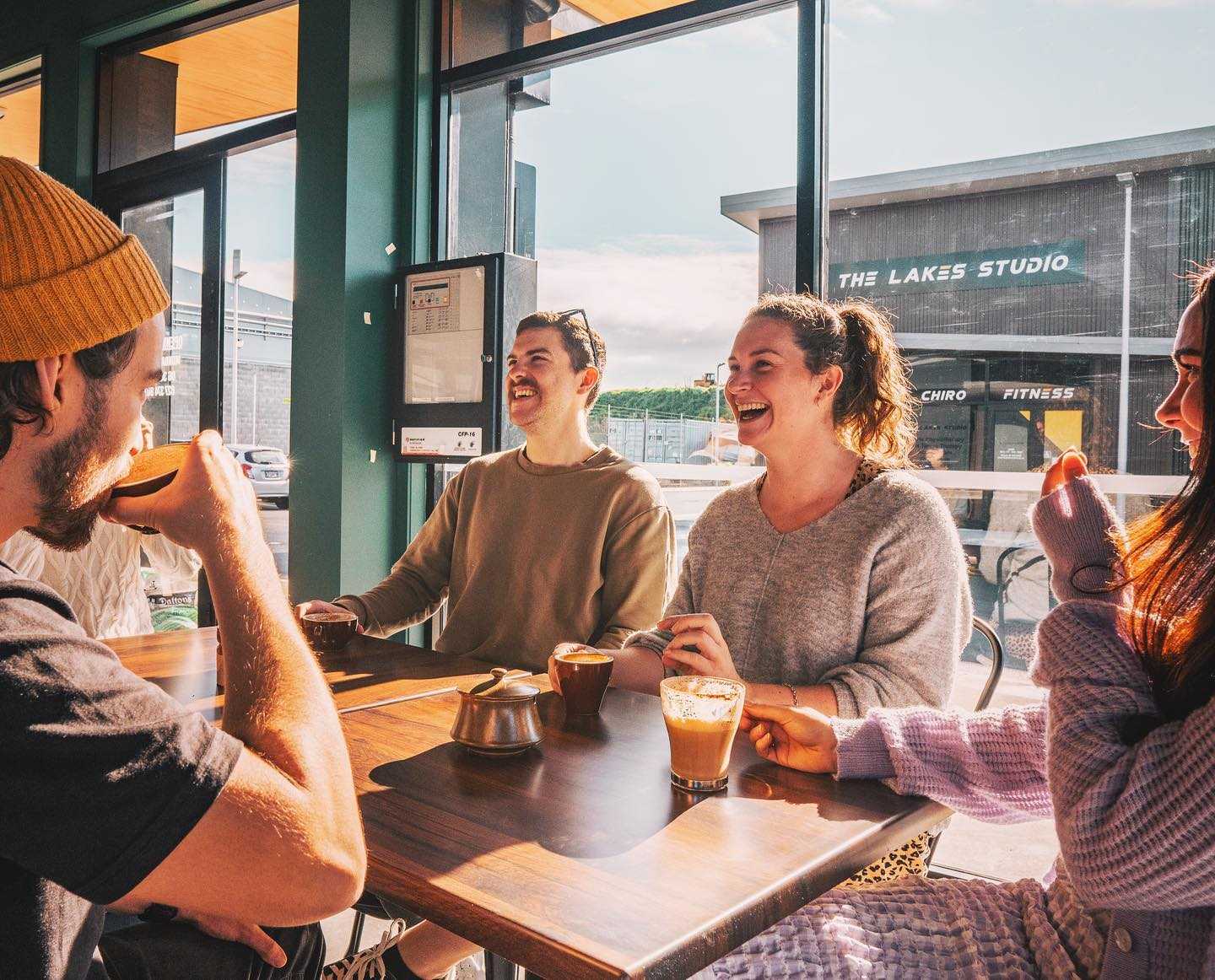 Image of people laughing and sipping coffee inside Ruthy's Cafe Tauranga