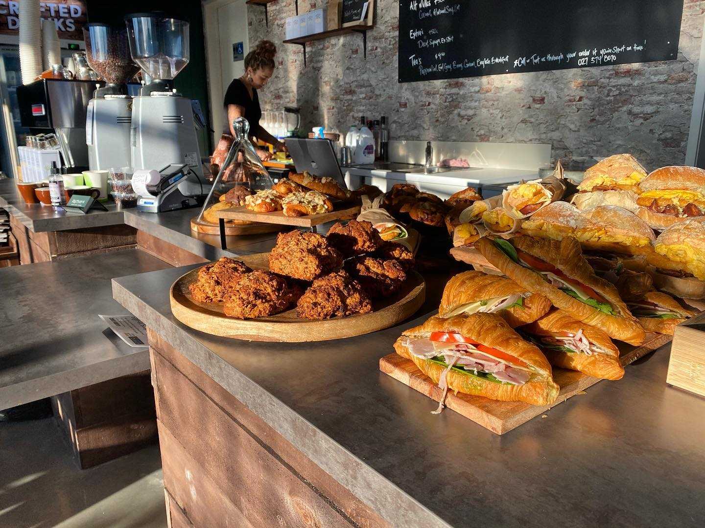 Image of food sitting on cafe counter with sunlight hitting it perfectly